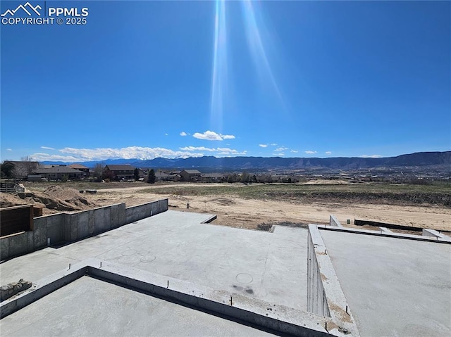 view of yard featuring a mountain view and a patio area