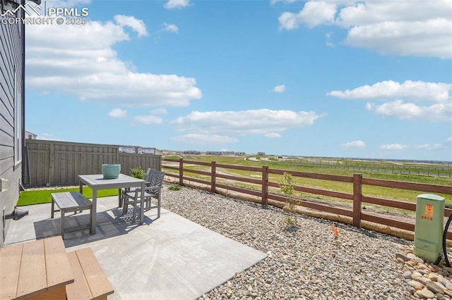 6913 Knapp Dr, Colorado Springs, CO 80924 - fenced backyard featuring outdoor dining area, a view of rural / pastoral area, and a patio area