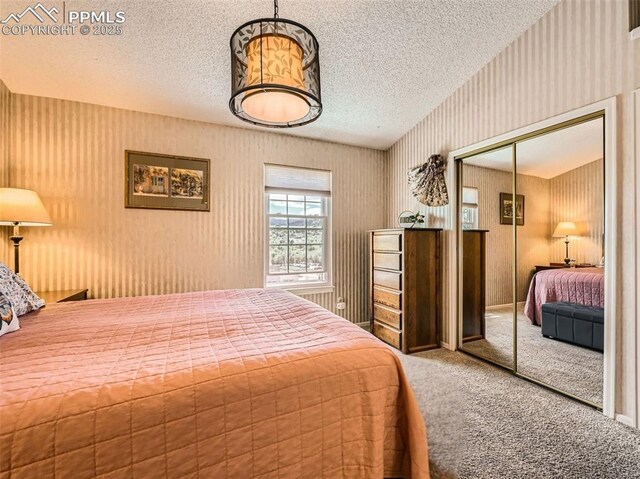 2186 Giltshire Dr, Colorado Springs, CO 80905 - carpeted bedroom featuring a closet, a textured ceiling, and wallpapered walls