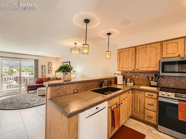 2186 Giltshire Dr, Colorado Springs, CO 80905 - kitchen featuring appliances with stainless steel finishes, a sink, dark countertops, and a peninsula