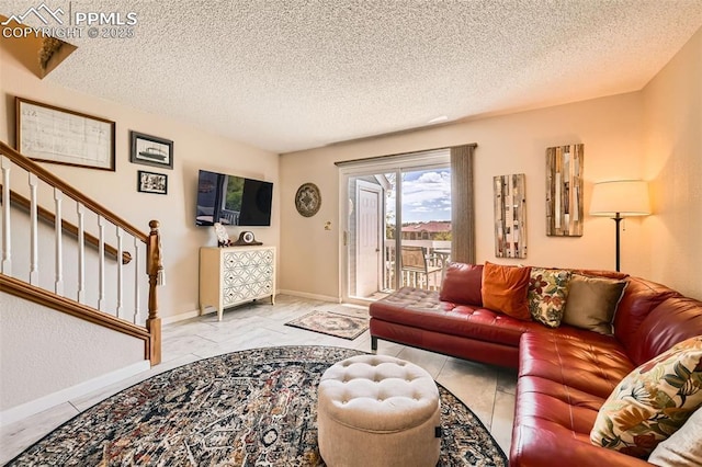 2186 Giltshire Dr, Colorado Springs, CO 80905 - living room featuring a textured ceiling, baseboards, and stairway
