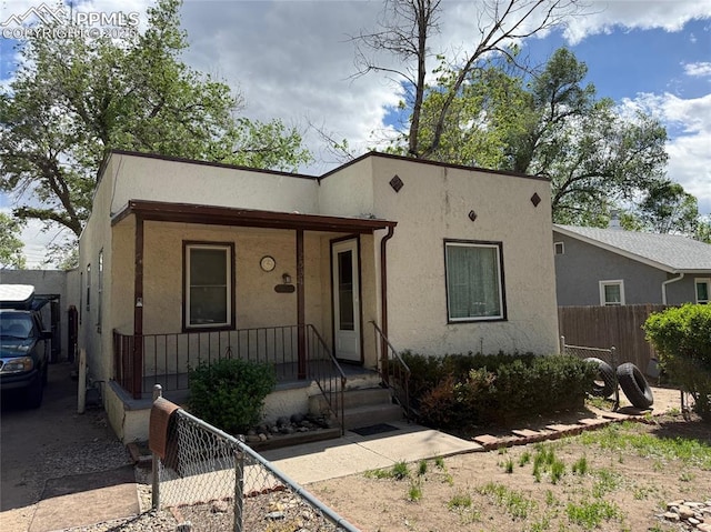 2531 Gunnison St, Colorado Springs, CO 80909 - view of front of home featuring stucco siding and covered porch
