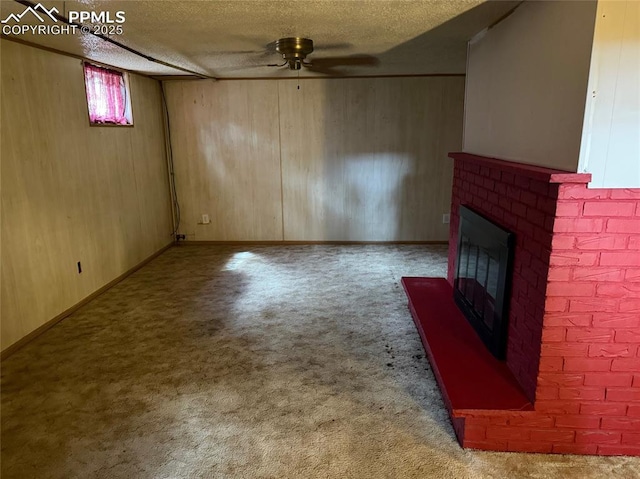 2531 Gunnison St, Colorado Springs, CO 80909 - unfurnished living room with a fireplace, carpet flooring, ceiling fan, wood walls, and a textured ceiling