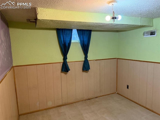 2531 Gunnison St, Colorado Springs, CO 80909 - carpeted spare room with a textured ceiling, a wainscoted wall, and wood walls