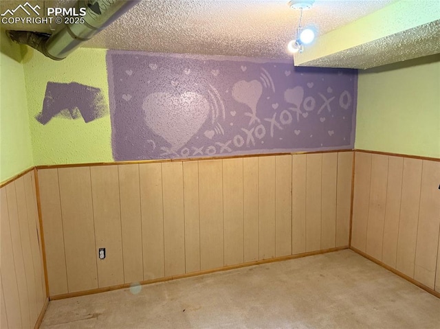 2531 Gunnison St, Colorado Springs, CO 80909 - carpeted spare room featuring a textured ceiling, wooden walls, and a wainscoted wall