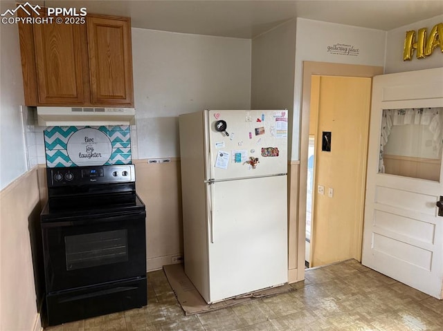 2531 Gunnison St, Colorado Springs, CO 80909 - kitchen with freestanding refrigerator, under cabinet range hood, black range with electric cooktop, brown cabinets, and decorative backsplash