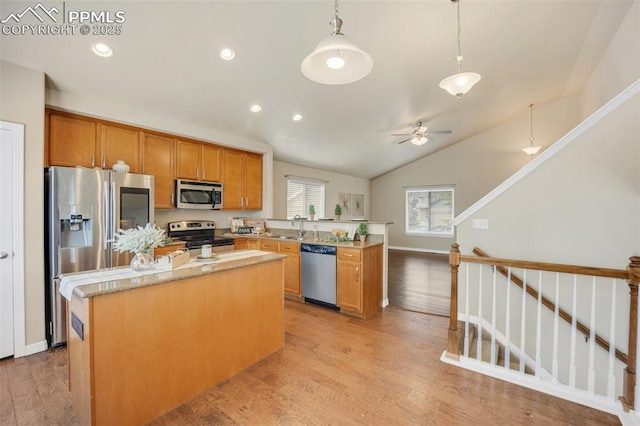 6259 Bearcat Loop, Colorado Springs, CO 80925 - kitchen with stainless steel appliances, light wood finished floors, a peninsula, a ceiling fan, and a sink