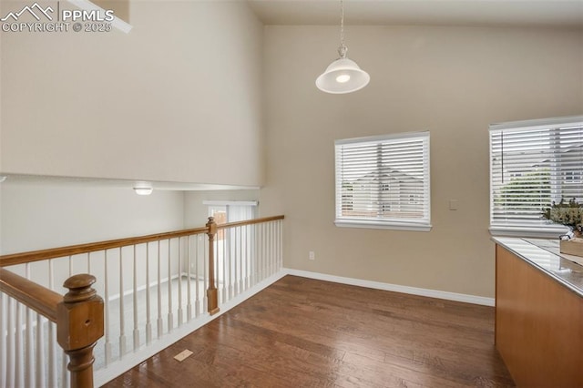 6259 Bearcat Loop, Colorado Springs, CO 80925 - unfurnished dining area with wood finished floors, baseboards, and a high ceiling