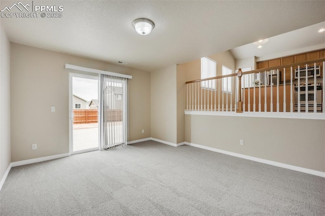 6259 Bearcat Loop, Colorado Springs, CO 80925 - carpeted spare room with baseboards and a textured ceiling