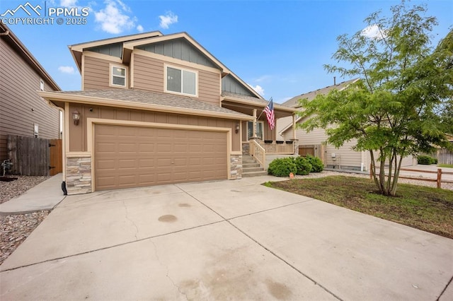 6259 Bearcat Loop, Colorado Springs, CO 80925 - view of front facade featuring stone siding, board and batten siding, an attached garage, and concrete driveway
