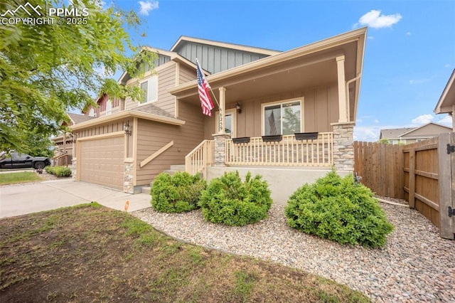6259 Bearcat Loop, Colorado Springs, CO 80925 - craftsman-style home with board and batten siding, a porch, driveway, stone siding, and a garage