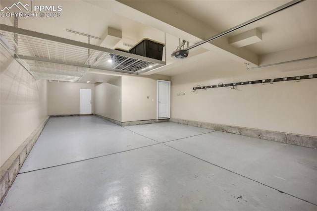 6259 Bearcat Loop, Colorado Springs, CO 80925 - garage featuring a garage door opener and baseboards