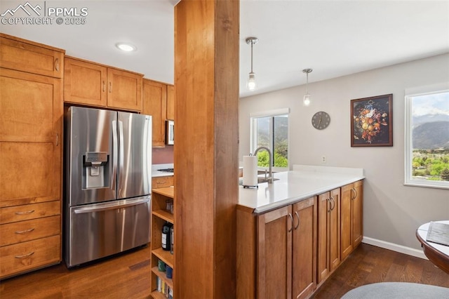 954 Fontmore Rd Unit B, Colorado Springs, CO 80904 - kitchen featuring stainless steel fridge with ice dispenser, brown cabinets, dark wood-style flooring, light countertops, and open shelves