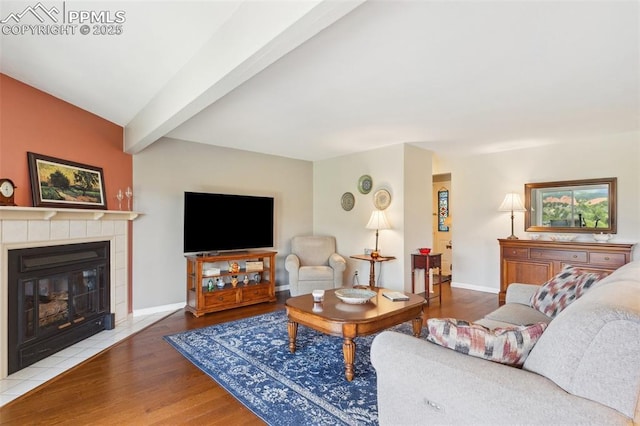 954 Fontmore Rd Unit B, Colorado Springs, CO 80904 - living room with wood finished floors, a tiled fireplace, baseboards, and beamed ceiling