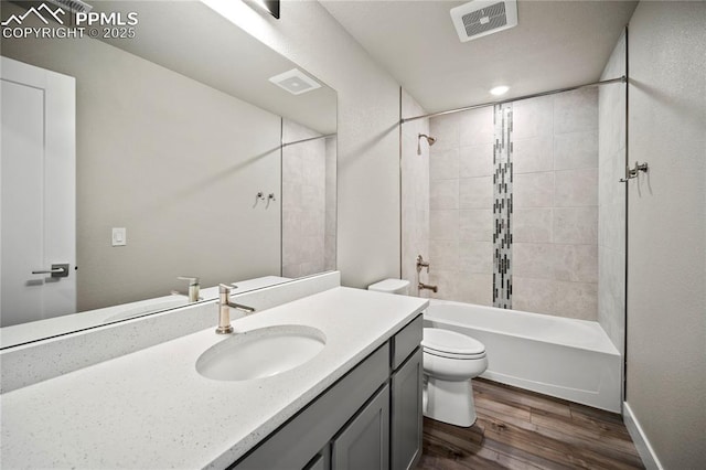 3065 Curly Grv, Colorado Springs, CO 80922 - bathroom with wood finished floors, toilet, vanity, bathtub / shower combination, and baseboards