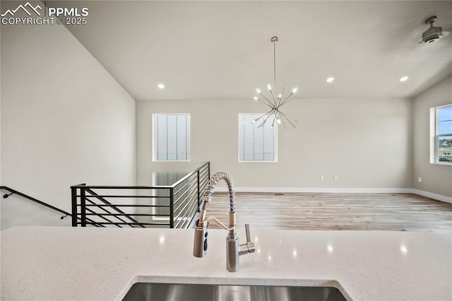 3065 Curly Grv, Colorado Springs, CO 80922 - kitchen featuring a sink, recessed lighting, baseboards, a chandelier, and light stone countertops