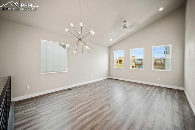 3065 Curly Grv, Colorado Springs, CO 80922 - unfurnished living room with a chandelier, wood finished floors, vaulted ceiling, baseboards, and recessed lighting