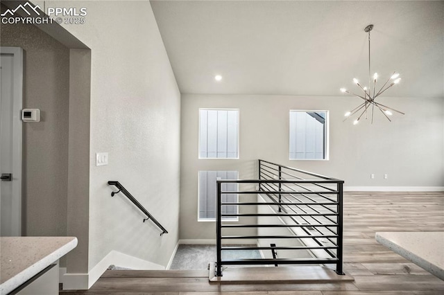 3065 Curly Grv, Colorado Springs, CO 80922 - staircase featuring a chandelier, baseboards, wood finished floors, and recessed lighting