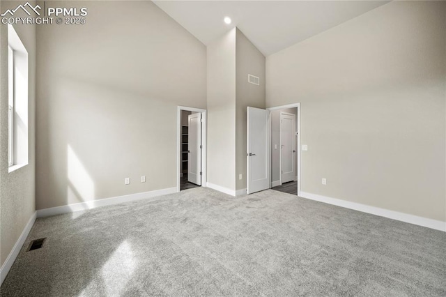 3065 Curly Grv, Colorado Springs, CO 80922 - unfurnished bedroom featuring high vaulted ceiling, carpet flooring, baseboards, and a walk in closet