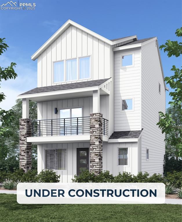 10790 Spalding Vw, Colorado Springs, CO 80908 - view of front of house with board and batten siding and a balcony
