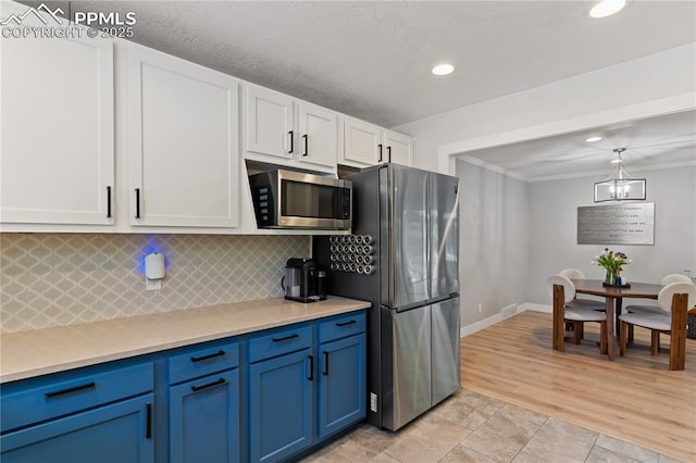 1107 Parkview Blvd, Colorado Springs, CO 80905 - kitchen featuring appliances with stainless steel finishes, white cabinets, light countertops, decorative backsplash, and recessed lighting