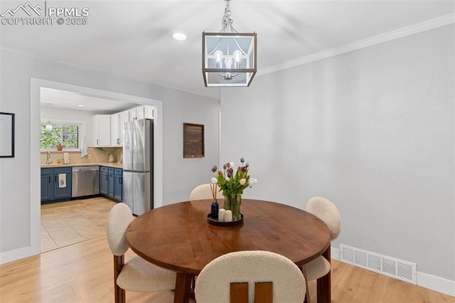 1107 Parkview Blvd, Colorado Springs, CO 80905 - dining area with a chandelier, light wood-style flooring, baseboards, recessed lighting, and crown molding