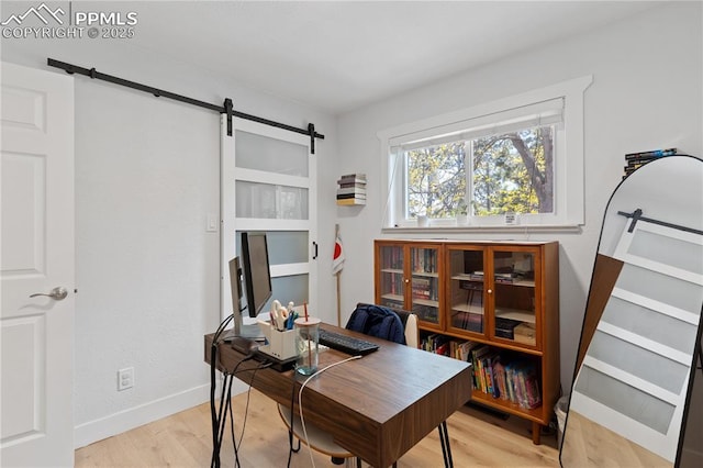 1107 Parkview Blvd, Colorado Springs, CO 80905 - home office with a barn door, light wood-style floors, and baseboards