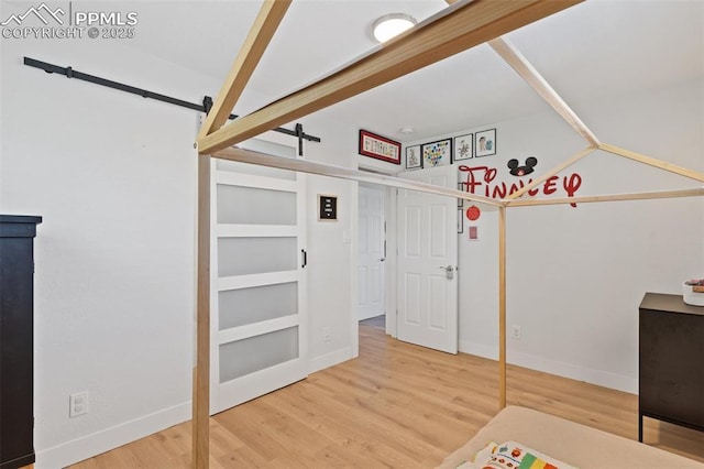 1107 Parkview Blvd, Colorado Springs, CO 80905 - rec room featuring wood finished floors, a barn door, and baseboards