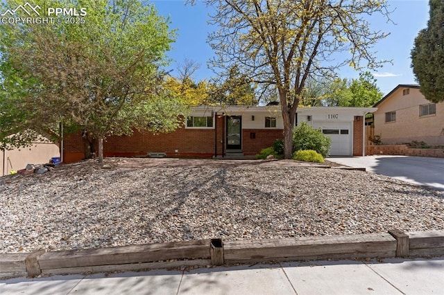 1107 Parkview Blvd, Colorado Springs, CO 80905 - single story home featuring brick siding, an attached garage, and concrete driveway