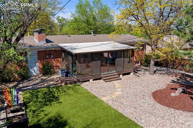 1107 Parkview Blvd, Colorado Springs, CO 80905 - rear view of house with a sunroom, a chimney, brick siding, and a shingled roof