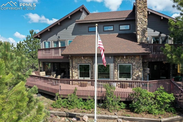 210 Mission Hill Way, Colorado Springs, CO 80921 - rear view of property with stone siding, a shingled roof, a balcony, and a deck