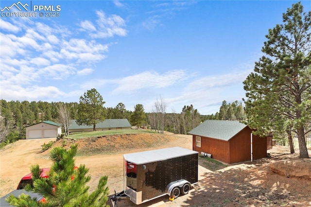 867 Twin Lakes Dr, Divide, CO 80814 - view of yard featuring an outbuilding and a garage