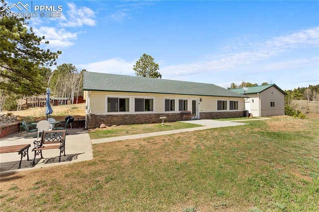 867 Twin Lakes Dr, Divide, CO 80814 - rear view of property featuring a patio area, a lawn, and stone siding