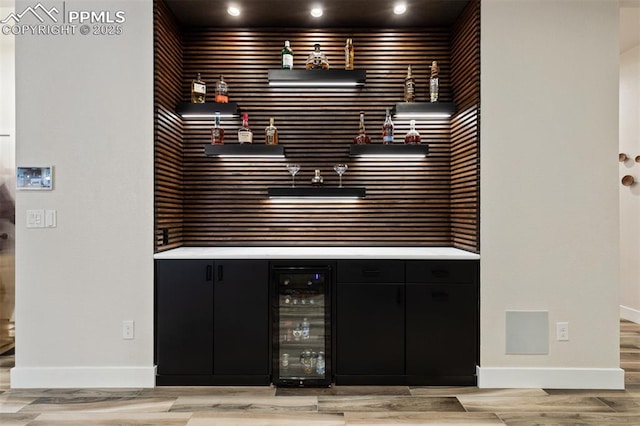 16244 Thunder Cat Way, Monument, CO 80132 - indoor dry bar with beverage cooler, baseboards, light wood finished floors, decorative backsplash, and recessed lighting