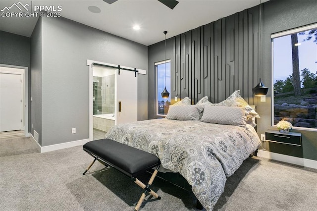 16244 Thunder Cat Way, Monument, CO 80132 - carpeted bedroom with a barn door, baseboards, and connected bathroom