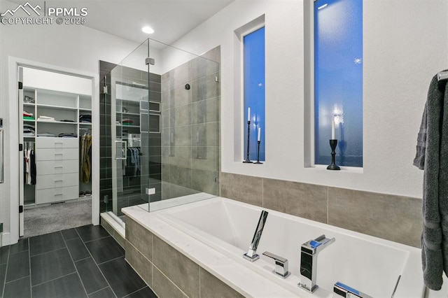16244 Thunder Cat Way, Monument, CO 80132 - full bathroom featuring a shower stall, a bath, a walk in closet, and tile patterned flooring