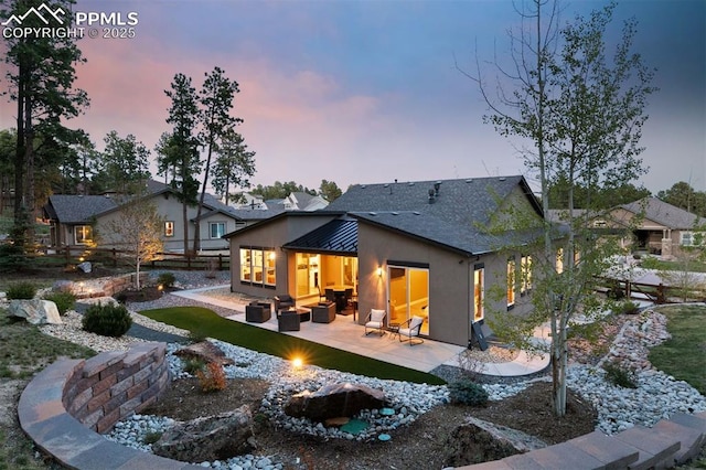 16244 Thunder Cat Way, Monument, CO 80132 - rear view of property with an outdoor living space with a fire pit, a patio area, and stucco siding