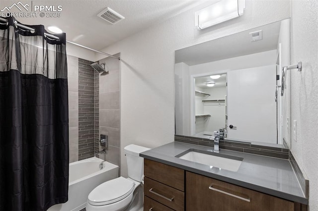 16244 Thunder Cat Way, Monument, CO 80132 - full bathroom featuring vanity, shower / bathtub combination with curtain, toilet, and a textured wall
