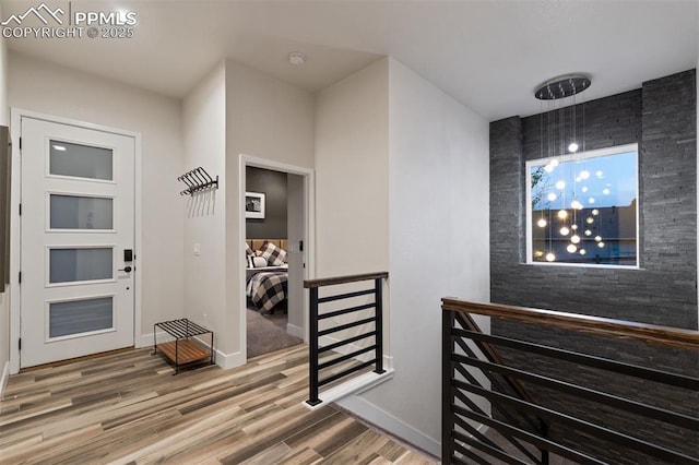 16244 Thunder Cat Way, Monument, CO 80132 - hallway with an upstairs landing, wood finished floors, and baseboards