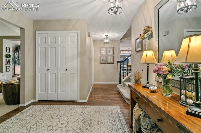 9131 Estebury Cir, Colorado Springs, CO 80920 - foyer with dark wood finished floors, a chandelier, and stairway