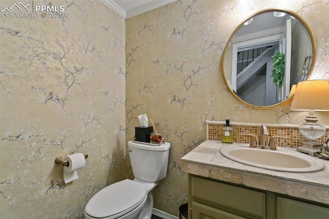 9131 Estebury Cir, Colorado Springs, CO 80920 - bathroom with crown molding, vanity, toilet, and tasteful backsplash