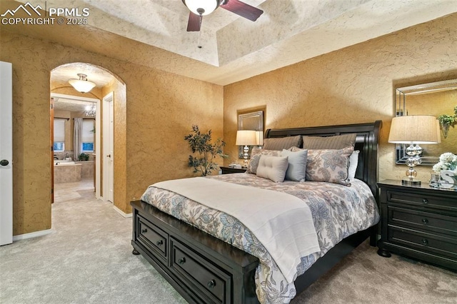 9131 Estebury Cir, Colorado Springs, CO 80920 - carpeted bedroom featuring arched walkways, a textured wall, baseboards, and a ceiling fan