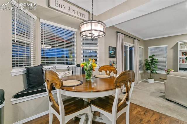 9131 Estebury Cir, Colorado Springs, CO 80920 - dining area with a chandelier, wood finished floors, baseboards, crown molding, and healthy amount of natural light
