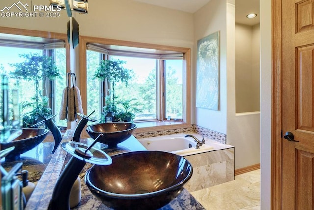 1120 Brenthaven Ct, Monument, CO 80132 - bathroom with a bath, a sink, and baseboards