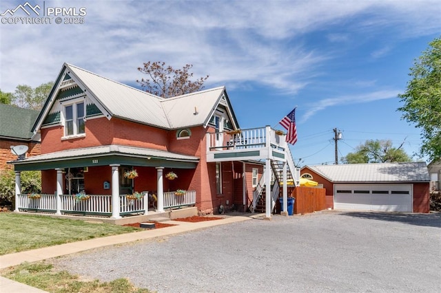 521 W Corona Ave, Pueblo, CO 81004 - view of front facade with a porch, stairway, a garage, brick siding, and metal roof