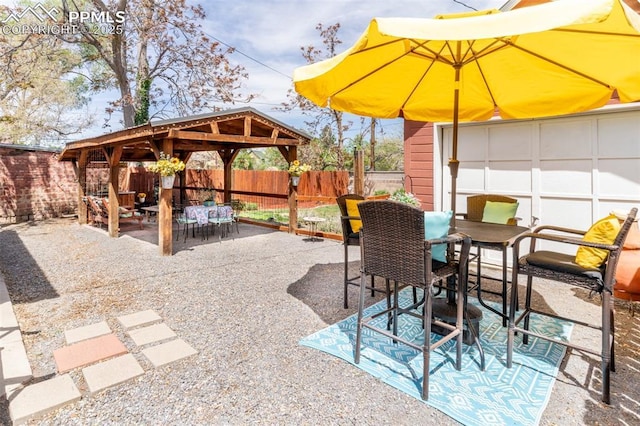521 W Corona Ave, Pueblo, CO 81004 - view of patio / terrace featuring outdoor dining space, a gazebo, and a fenced backyard