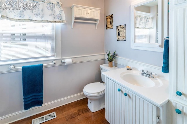 521 W Corona Ave, Pueblo, CO 81004 - bathroom with wood finished floors, toilet, and vanity