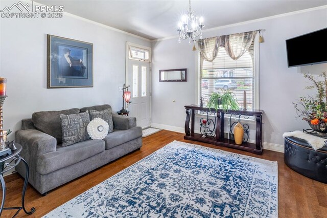 521 W Corona Ave, Pueblo, CO 81004 - living room with crown molding, a chandelier, wood finished floors, and baseboards