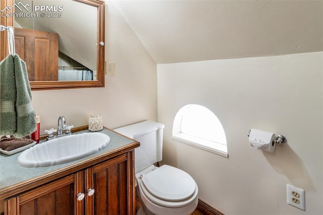 521 W Corona Ave, Pueblo, CO 81004 - bathroom with vaulted ceiling, toilet, and vanity
