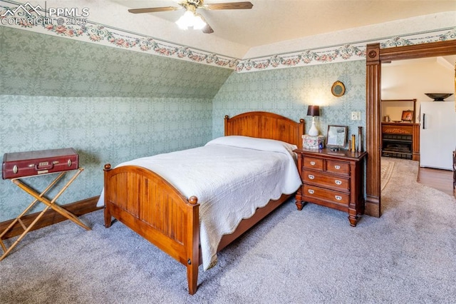 521 W Corona Ave, Pueblo, CO 81004 - carpeted bedroom with wallpapered walls, ceiling fan, and lofted ceiling